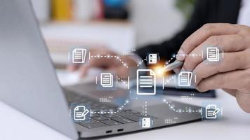 Businessman working with electronics document icons, E-document management, online documentation database, paperless office concept photo
