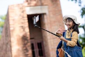 Happy kid girls taking selfies. taking selfie photos with a smartphone