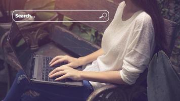 People hand using laptop or computor searching for information in internet online society web with search box icon and copyspace. photo