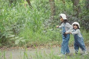 Children are heading to the family campsite in the forest Walk along the tourist route. Camping road. Family travel vacation concept. photo