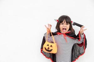 Funny Halloween Kid Concept, little cute girl with costume Halloween ghost scary he holding orange pumpkin ghost on hand, on white background photo