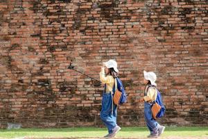 Two Asian children girls are bloggers. Broadcast on the Internet. Record vlog and blog subscribers. Record video lessons for Internet. Use camera with tripod. photo