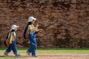 Two Asian children girls are bloggers. Broadcast on the Internet. Record vlog and blog subscribers. Record video lessons for Internet. Use camera with tripod. photo