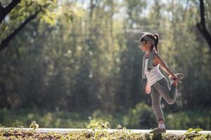 Cute asian girl exercise in gardent background photo