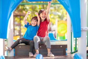 Child playing on the outdoor playground. Kids play in school or kindergarten yard. photo