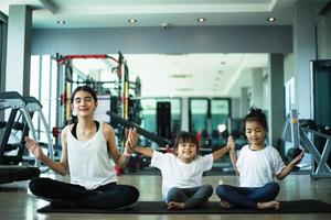 Group of children doing gymnastic exercises photo