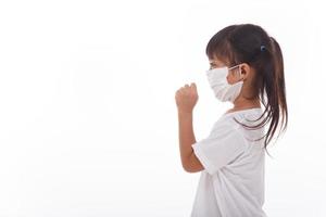 asia girl wearing mask to prevent the virus PM2.5, Coronavirus, 2019-nCoV asian little girl feeling unwell and coughing as symptom for cold or pneumonia,on white background photo