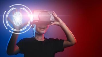 happy girl in glasses of virtual reality. Augmented reality, science, future technology concept. VR. Futuristic 3d glasses with virtual projection. Neon light. photo