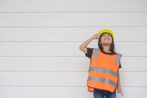 Asian Kid girl wearing reflective shirts and a hat yellow. To learning and enhance development, little architect. photo