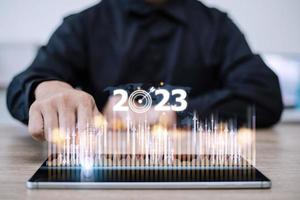 Business and Technology target set goals and achievement in 2023 new year resolution statistics graph rising revenue, planning to start up strategy, icon concept photo