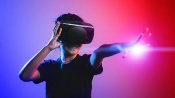 happy girl in glasses of virtual reality. Augmented reality, science, future technology concept. VR. Futuristic 3d glasses with virtual projection. Neon light. photo