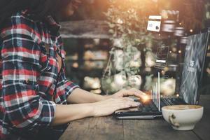 Business, technology, internet and networking concept. businesswoman working on his laptop at home, select the icon on the virtual screen. photo