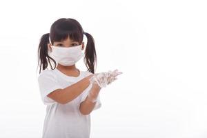 child washing hands and showing soapy palms.on white background photo