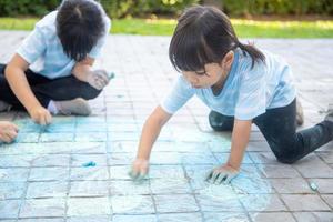 Children playing with colored chalks photo