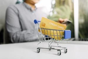 Woman hand using mobile smart phone, online payment, banking and online shopping at the home. photo