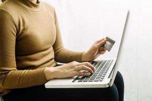 Woman hand using mobile smart phone, online payment, banking and online shopping at the home. photo