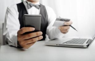 Woman hand using mobile smart phone, online payment, banking and online shopping at the home. photo