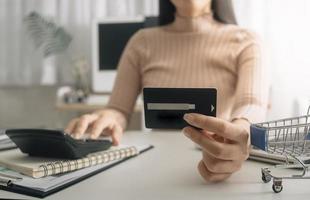 Woman hand using mobile smart phone, online payment, banking and online shopping at the home. photo