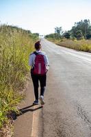 woman with backpack walking photo