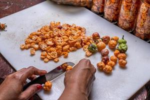 slicing many yellow peppers photo