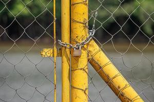 metal gate locked with chain and padlock photo