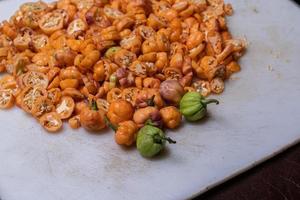 Many small fruit yellow peppers photo