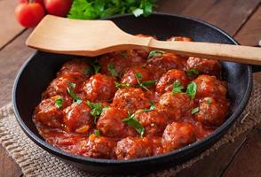 Meatballs in sweet and sour tomato sauce. photo