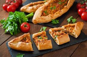 Turkish pide traditional food with beef and vegetables photo