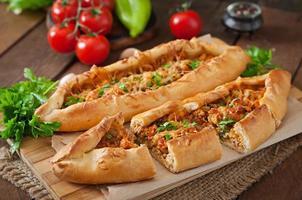 Turkish pide traditional food with beef and vegetables photo