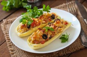 Stuffed zucchini with chicken, tomatoes and olives with cheese crust photo