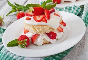 Sponge cake with cream and strawberries photo