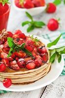 Pancakes with berries and strawberry smoothie in a rustic style photo