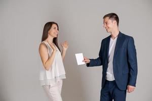 Young successful woman received business document from business man photo