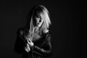 Portrait of a woman in a leather jacket and lingerie, black and white photo