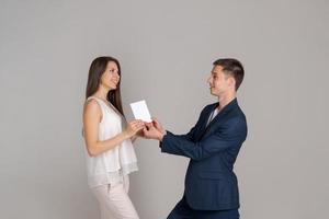 Young successful woman received business document from business man photo