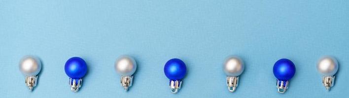 New year's composition. Christmas balls of blue and silver color lie in a row photo