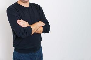Business man employer arms crossed in dark clothes on gray background. photo