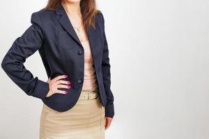 Business woman in black jacket and beige skirt with no face on light photo