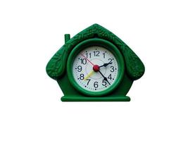 Desktop green clock in the form of a house on a white background photo