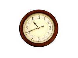 Wall clock with a brown frame on a white background photo