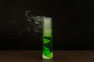 Dry ice reacts with green water to produce smoke. photo