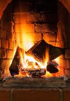 burning firewood in fire-box of fireplace photo