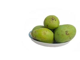 mangoes placed on a glass plate on a white background photo
