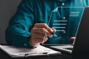 Electronic Signature Concept, Electronic Signing Businessman signs electronic documents on digital documents on virtual laptop screen. photo