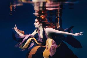 beautiful artistic young woman in dress dancing underwater. Mermaid, harvest, dance, fairy concept photo