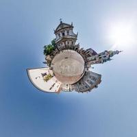 Little planet and spherical aerial 360 panorama view on street ancient medieval city with church and historic buildings photo