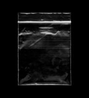 Blank transparent plastic bag overlay on black background photo