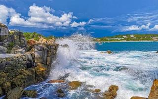 Beautiful surfer waves rocks cliffs at beach Puerto Escondido Mexico. photo