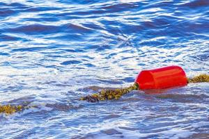 Blue water waves and ocean with buoy and ropes Mexico. photo