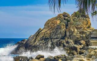 Beautiful surfer waves rocks cliffs at beach Puerto Escondido Mexico. photo